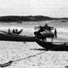 A Marine Ontos patrols a beach area during Operation STARLITE. The South Vietnamese fishermen go  about their business despite the war. (USMC Photo A185826)