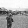 Marines from the 2d Battalion, 4th Marines assemble near a small hamlet during Operation STARLITE, The unit pictured is a command group; note the number of radio antennas.